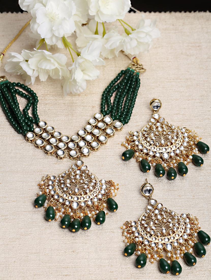 green metal necklaces and earring